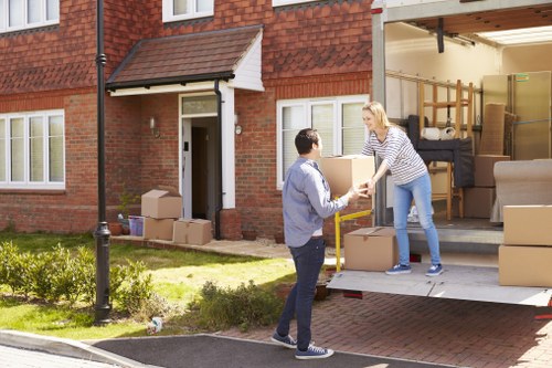 Furniture and boxes being loaded into a removals van in West London
