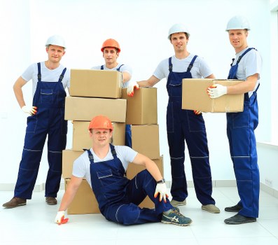 Loading boxes and furniture into a moving truck in Ealing