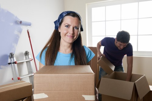 Man with van removal team loading items for an Ealing move