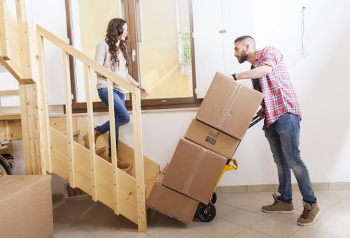Removals team loading boxes and furniture for a West London house relocation